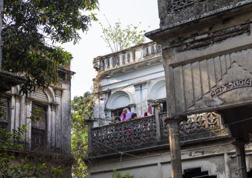 Bangladeshi mother with her children on an heritage house balcony, Dhaka Division, Munshiganj, Bangladesh