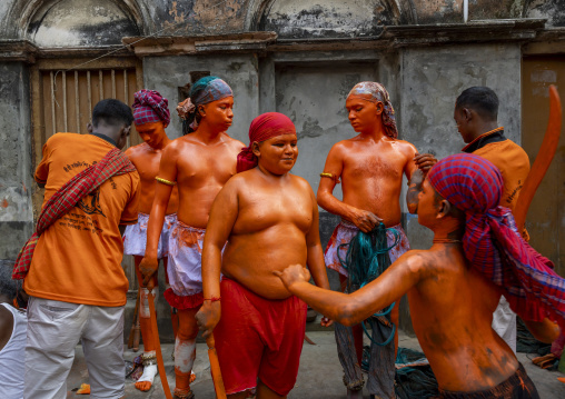 Make up of Hindu devotees covered with orange color at Lal Kach festival, Dhaka Division, Munshiganj, Bangladesh