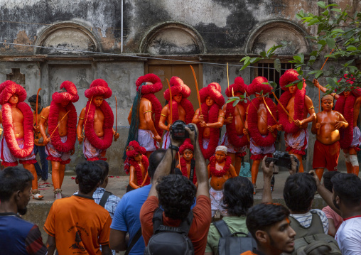 Photographers taking pictures of a hindu devotee at Lal Kach festival, Dhaka Division, Munshiganj, Bangladesh