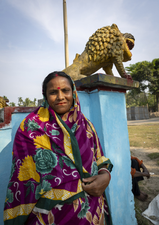 Portrait of a hindu woman against a blue wall with a lion statue, Sylhet Division, Kamalganj, Bangladesh