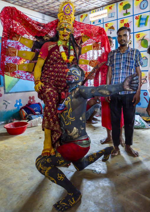 Parvati and Osur dressing in a school for Charak Puja hindu festival, Sylhet Division, Kamalganj, Bangladesh