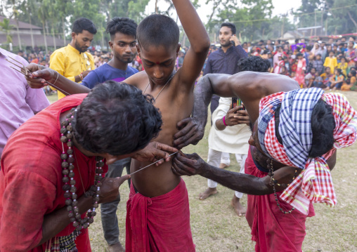 Boy having body piercing during Charak Puja hindu festival, Sylhet Division, Kamalganj, Bangladesh