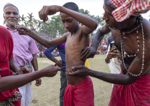 Boy having body piercing during Charak Puja hindu festival, Sylhet Division, Kamalganj, Bangladesh
