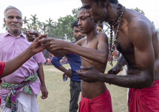 Boy having body piercing during Charak Puja hindu festival, Sylhet Division, Kamalganj, Bangladesh