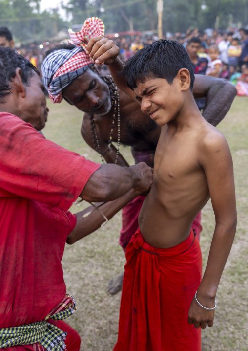 Boy having body piercing during Charak Puja hindu festival, Sylhet Division, Kamalganj, Bangladesh