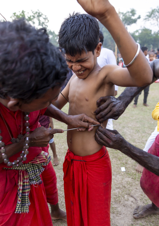 Boy having body piercing during Charak Puja hindu festival, Sylhet Division, Kamalganj, Bangladesh