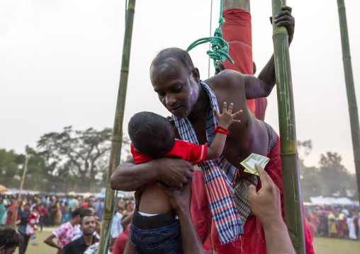 Devotee blessing a baby after body suspension during Charak Puja, Sylhet Division, Kamalganj, Bangladesh