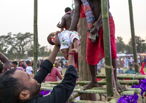 Devotee blessing a baby after body suspension during Charak Puja, Sylhet Division, Kamalganj, Bangladesh