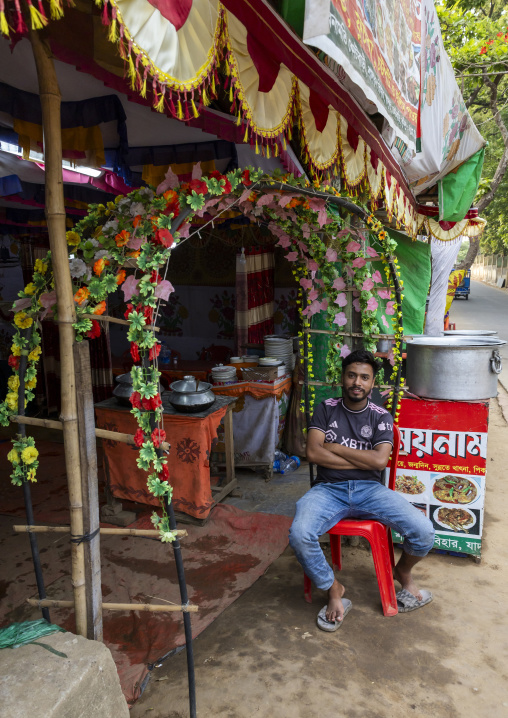 Bangladeshi man sit at the entrance of a restaurant, Chittagong Division, Comilla, Bangladesh