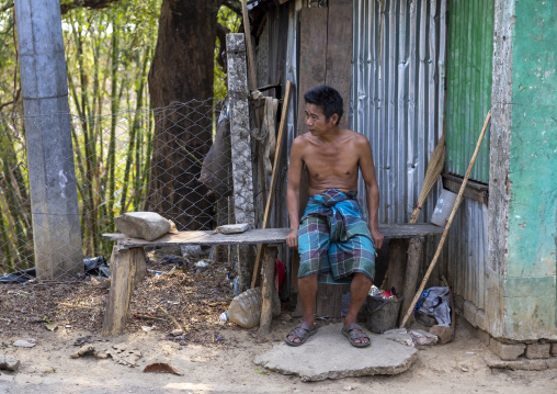 Tanchangya ethnic group  man sit on a bench in the street, Chittagong Division, Bandarban, Bangladesh