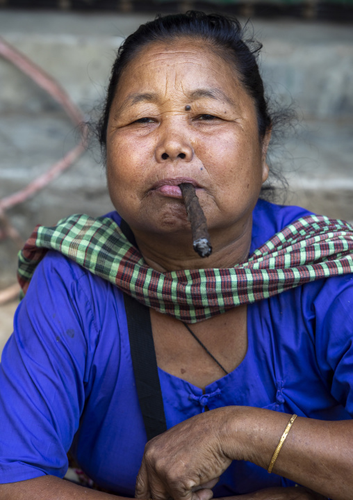 Woman smoking a cigar, Chittagong Division, Bandarban, Bangladesh