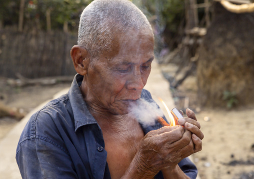 Marma old man smoking a cigar, Chittagong Division, Rowangchhari, Bangladesh