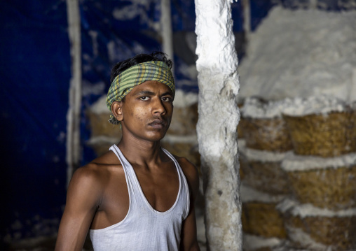 Bangladeshi man working in a salt factory, Chittagong Division, Chittagong, Bangladesh