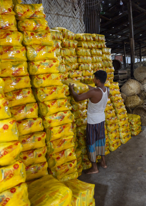 Bangladeshi man packing salt in plastic bags, Chittagong Division, Chittagong, Bangladesh