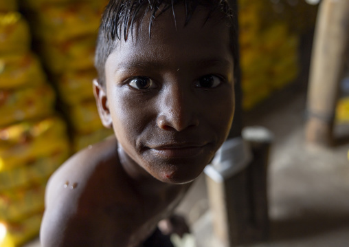 Bangladeshi boy working in a salt factory, Chittagong Division, Chittagong, Bangladesh