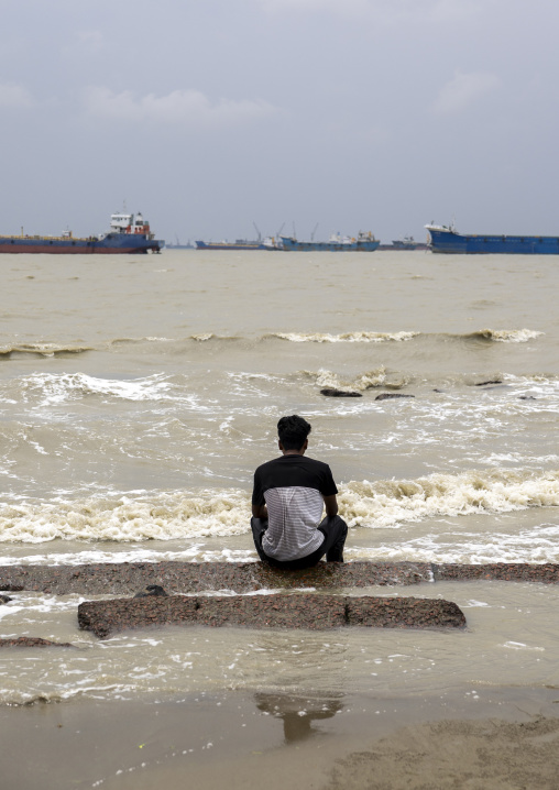 Man on the beach looking at tanker ships, Chittagong Division, Chittagong, Bangladesh