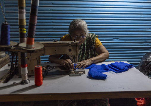Bangladeshi old woman sewing inside the market, Dhaka Division, Dhaka, Bangladesh