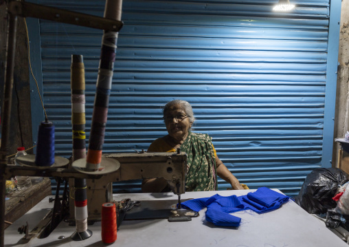 Bangladeshi old woman sewing inside the market, Dhaka Division, Dhaka, Bangladesh