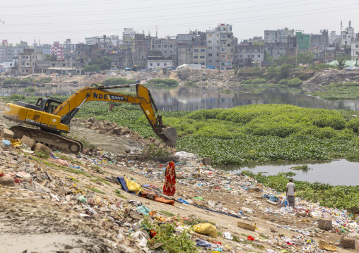 People collecting garbages in a dump near an excavator, Dhaka Division, Dhaka, Bangladesh