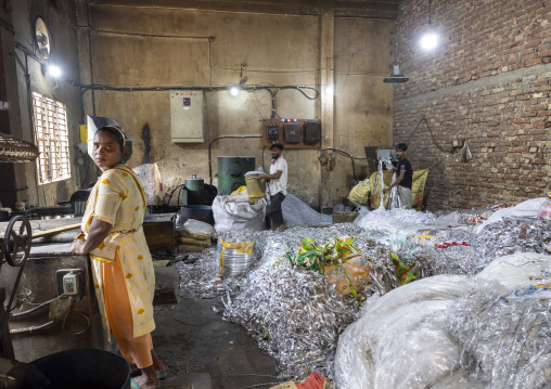 Bangladeshi workers dismantling plastic bags for recycling, Dhaka Division, Dhaka, Bangladesh
