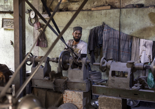 Bangladeshi worker making metal bowls, Dhaka Division, Dhaka, Bangladesh