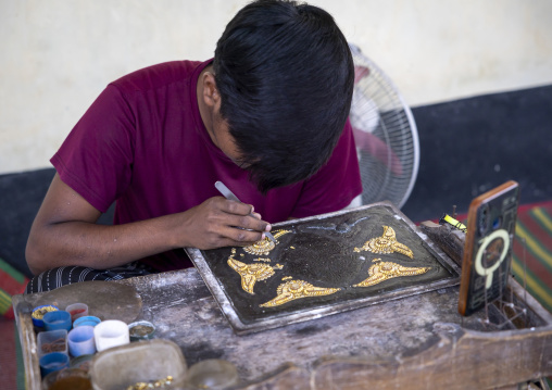 Metal worker using old lost wax casting method to create jewels, Dhaka Division, Dhamrai, Bangladesh