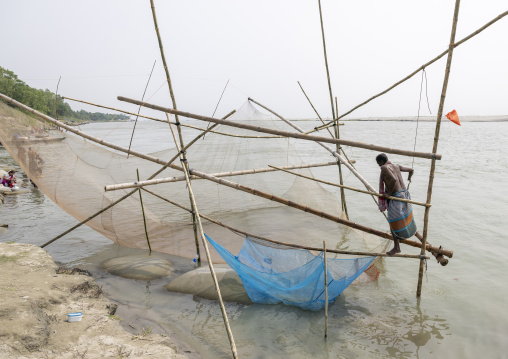 Traditional fishing net which functions on the principle of balance, Dhaka Division, Shivalaya, Bangladesh