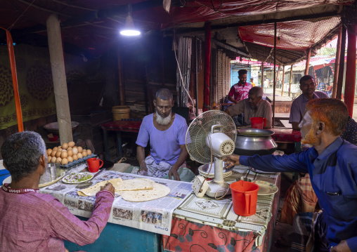 Bnagladeshi man selling rotis in the market, Rajshahi Division, Shibganj, Bangladesh