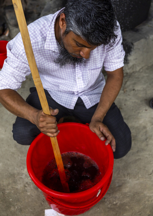 Mister Massoud dyeing fabrics in red in Living Blue company, Rangpur Division, Goalpara, Bangladesh