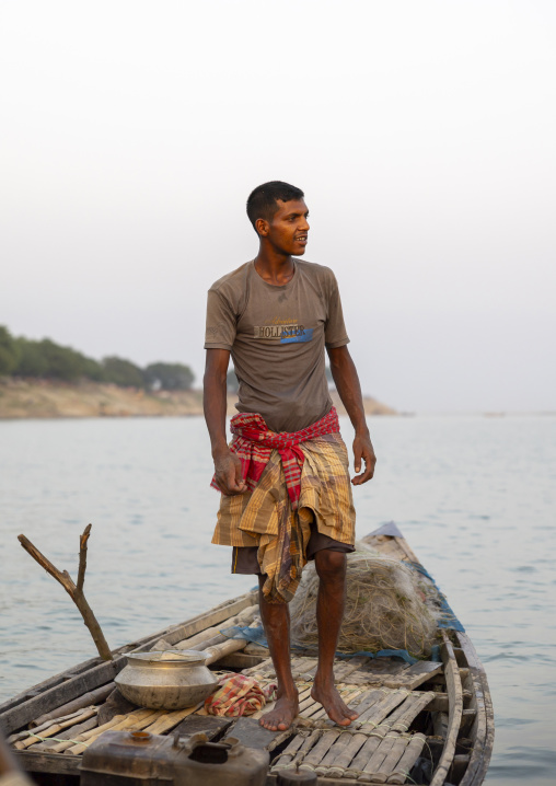 Bangladeshi fisherman on his boat, Rajshahi Division, Rajshahi, Bangladesh