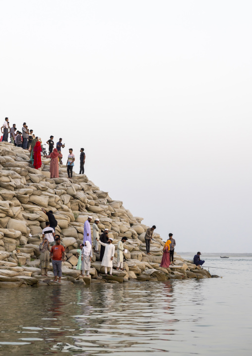 People walking on bags filled with sand to prevent from erosion, Rajshahi Division, Rajshahi, Bangladesh