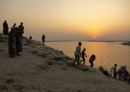 People walking on bags filled with sand to prevent from erosion, Rajshahi Division, Rajshahi, Bangladesh