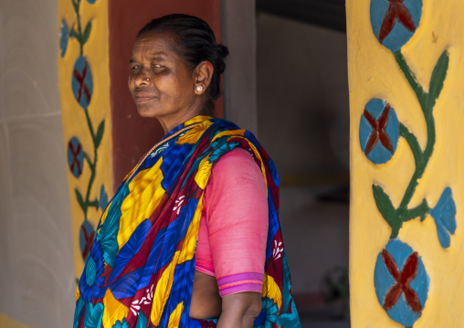 Christian woman from Santal ethnic group in front of a decorated door, Rajshahi Division, Tanore, Bangladesh