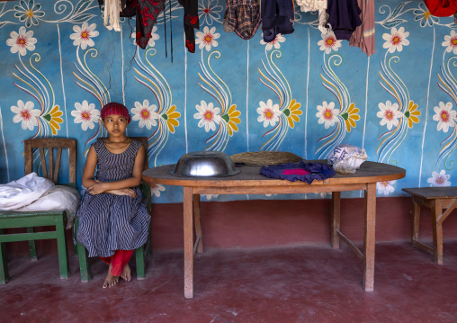 Bangladeshi girl in front of a traditional wall painting in a house, Rajshahi Division, Tikoil, Bangladesh