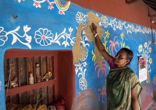 Bangladeshi woman in front of a traditional wall painting in a house, Rajshahi Division, Tikoil, Bangladesh