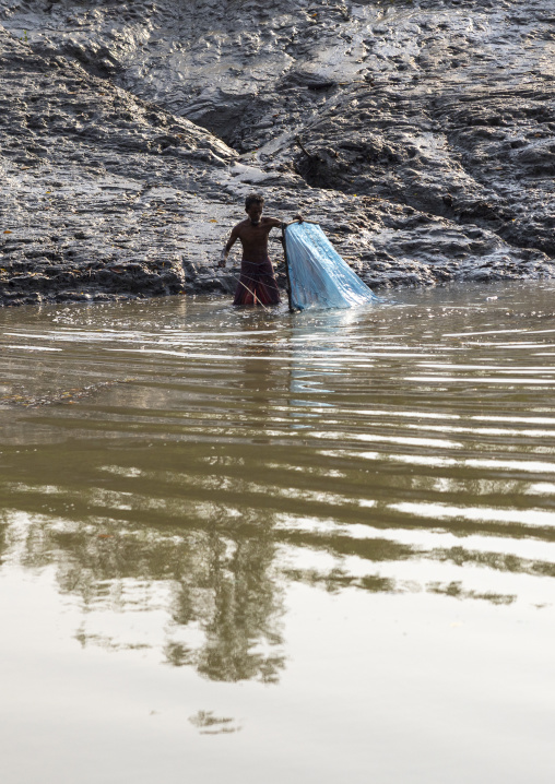 Bangladeshi man fishing shrimps in the river, Khulna Division, Mongla, Bangladesh