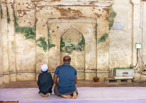 Father and son praying inside Qasba Mosque, Barisal Division, Gournadi, Bangladesh