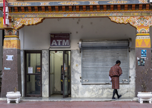 Bhutanese man coming out of an Atm machine, Chang Gewog, Thimphu, Bhutan