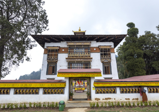 Bhutanese woman spiniing a prayer wheels in Tashigang Gonpa, Punakha dzongkhag, Punakha, Bhutan