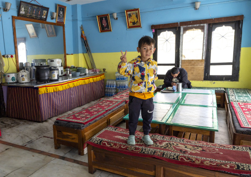 Boy in a bhutanese restaurant, Thedtsho Gewog, Wangdue Phodrang, Bhutan