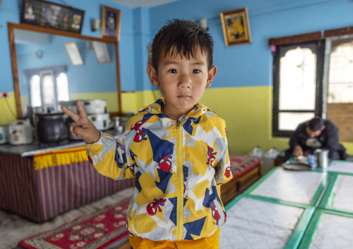 Boy in a bhutanese restaurant, Thedtsho Gewog, Wangdue Phodrang, Bhutan