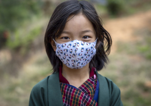 Portrait of a bhutanese girl with a covid mask, Wangdue Phodrang, Rubesagewog, Bhutan