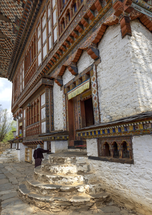 Bhutanese woman spiniing a prayer wheels in Ogyen Choling, Bumthang, Ogyen Choling, Bhutan