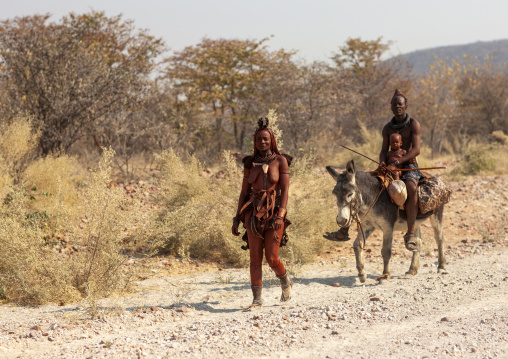 Himba family with a donkey, Kunene region, Epupa, Namibia