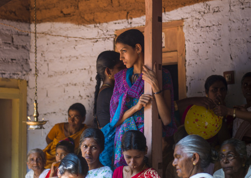 Young woman in the audience during a theyyam ceremony, Kerala, Thalassery, India