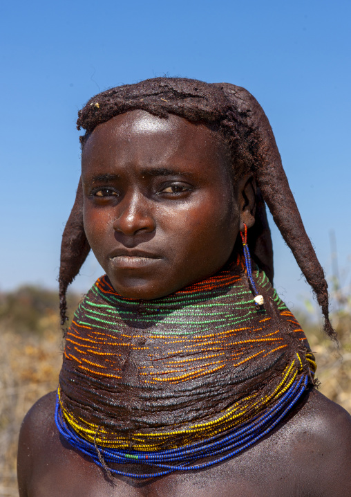 Mumuhuila tribe teenage girl wearing a huge necklace, Huila province, Chibia, Angola