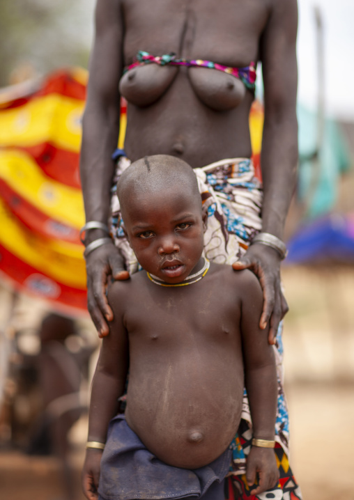Mucubal tribe boy with his mother, Namibe Province, Virei, Angola