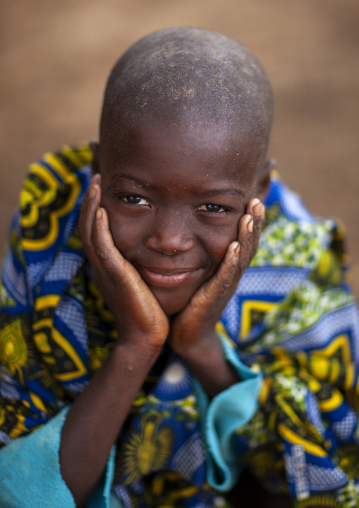 Mucubal tribe boy holding his face, Namibe Province, Virei, Angola