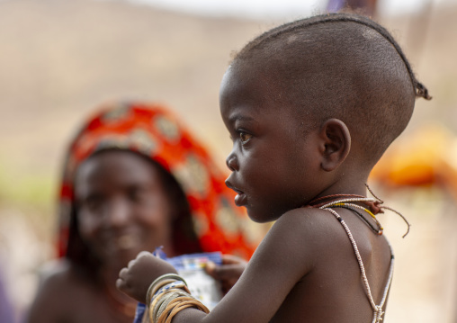 Mucubal tribe boy with women, Namibe Province, Virei, Angola