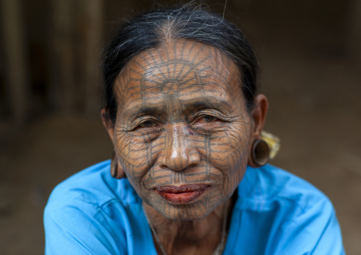 Tribal chin woman with spiderweb tattoo on the face, Rakhine state, Mrauk U, Myanmar